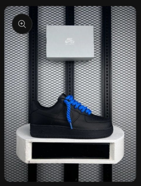 Low-top leather sneakers in black with chunky blue rope laces