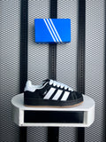 Black and white low-profile trainer with gum sole