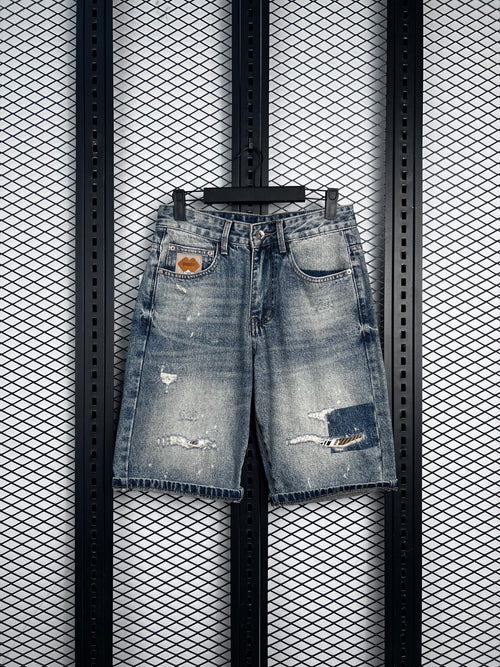 Bermuda cut denim shorts with distressed patch details