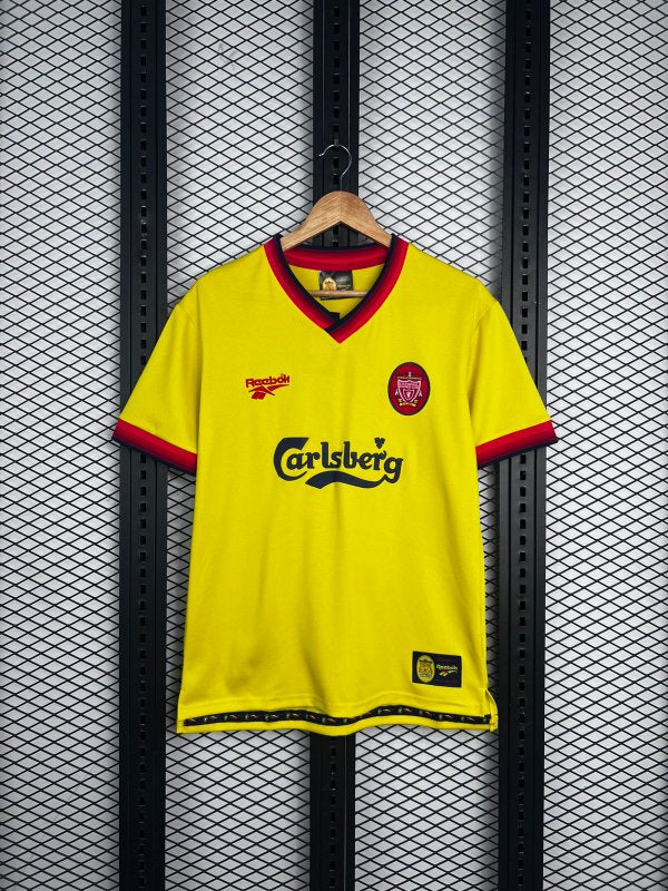 V-neck football silhouette in yellow with striped collar