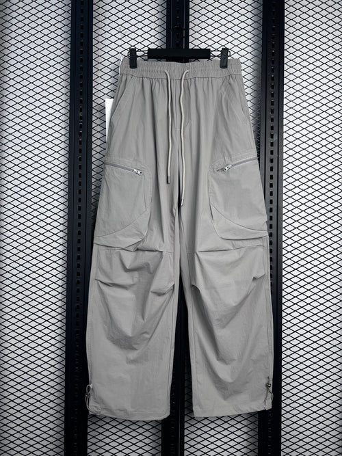 Drawstring-waist nylon parachute trousers with zip pockets