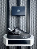 Contrast-stitched black patent and matte leather trainer
