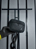 Black debossed monogram zip pouch with metallic hardware